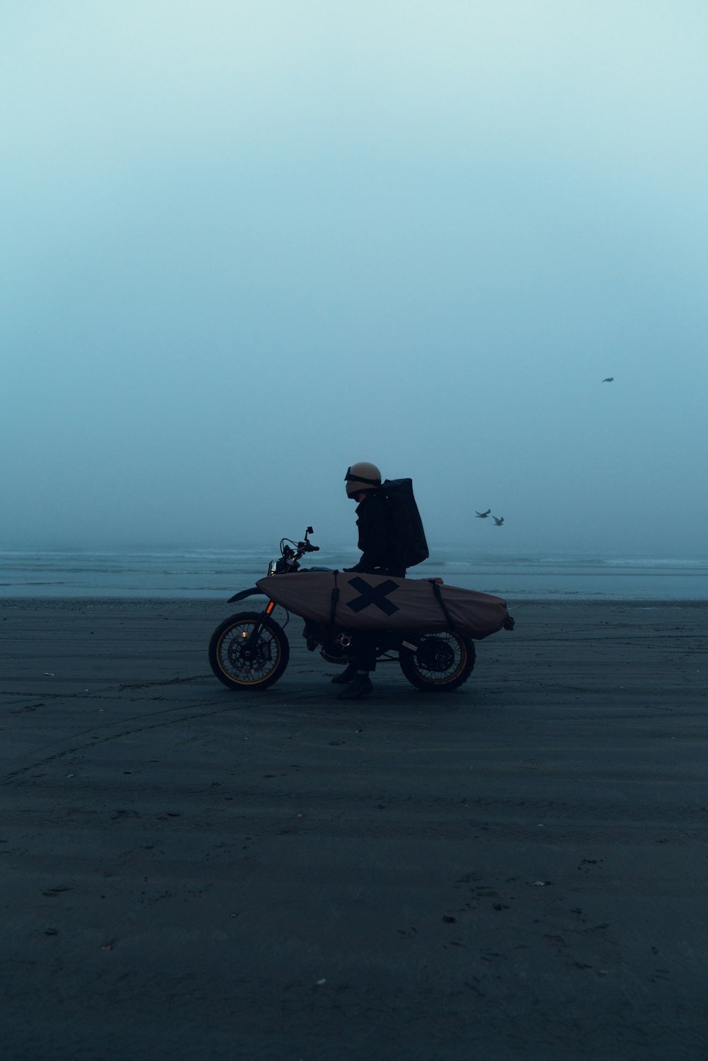 a person on a motorcycle on a beach