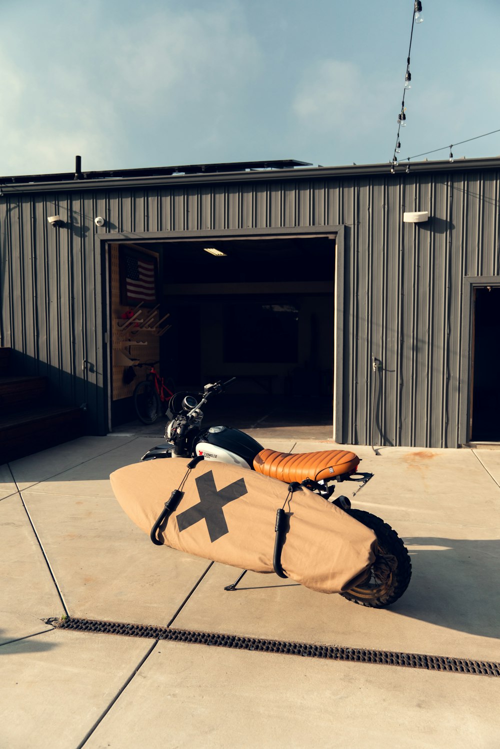 a motorcycle with a surfboard strapped to the back of it