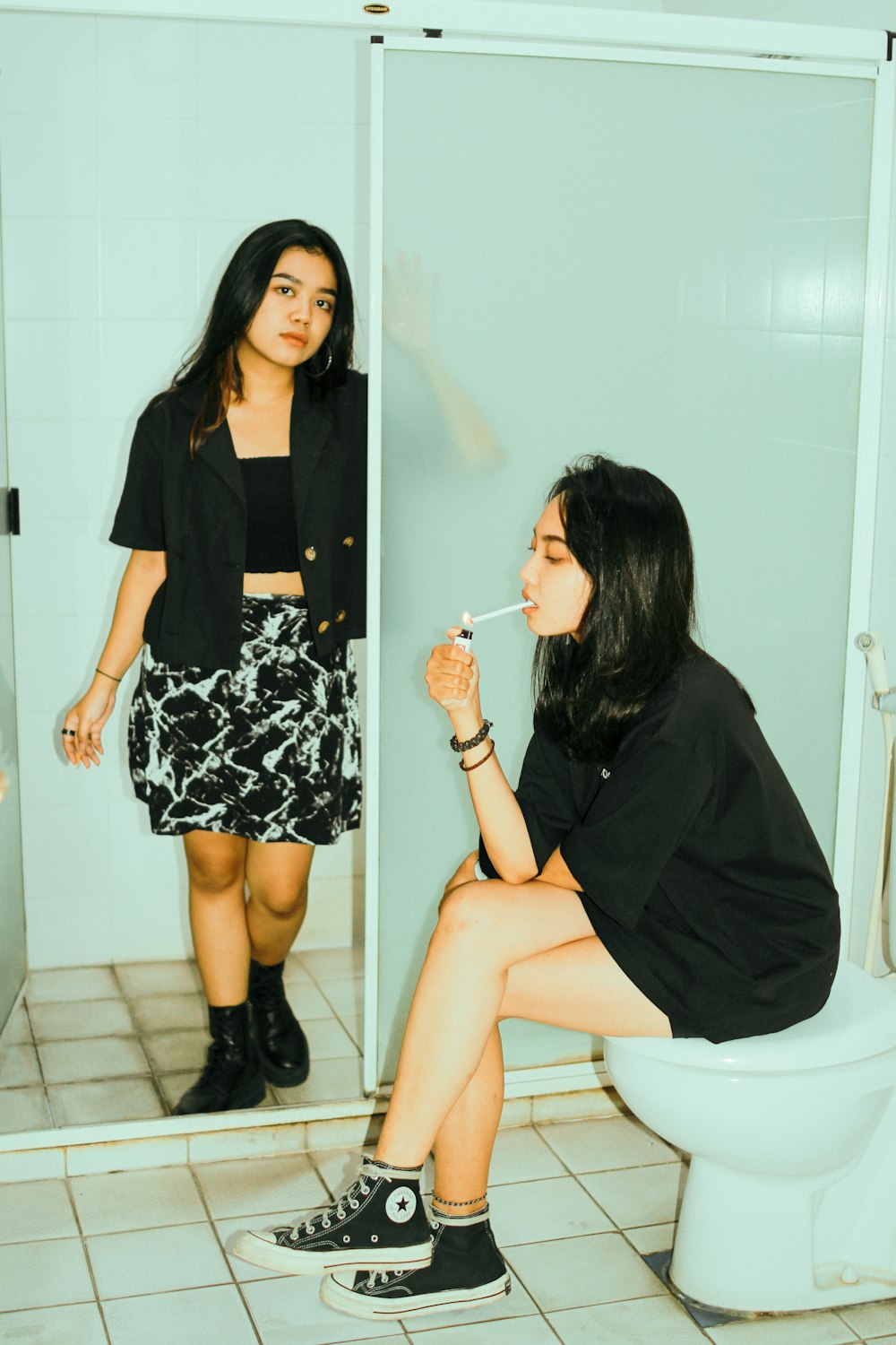 a woman sitting on a toilet in a bathroom