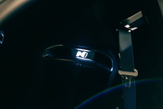 A dynamic photo of a sleek car interior illuminated by soft purple dashboard lights, reflecting the brand’s colour scheme.