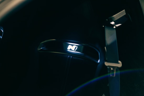 A dynamic photo of a sleek car interior illuminated by soft purple dashboard lights, reflecting the brand’s colour scheme.