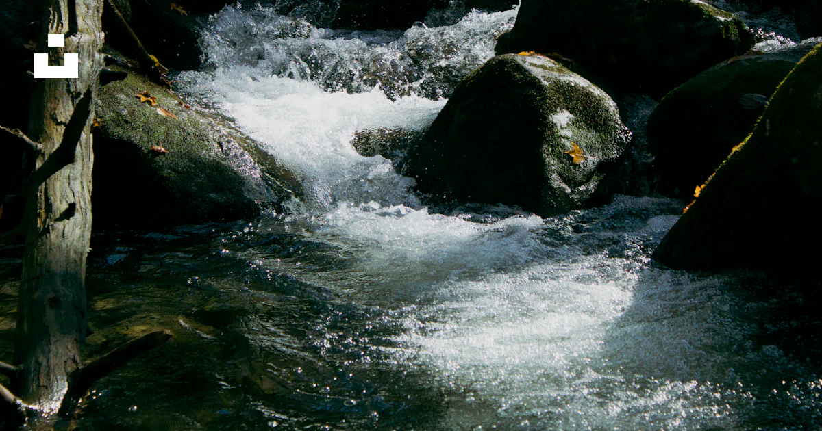 Stream Between Two Rocks A stream of water running between two large rocks photo – Free Great ...