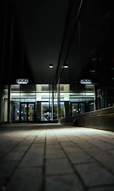 A sleek, dark-themed office lobby with a person effortlessly entering using hands-free access technology.