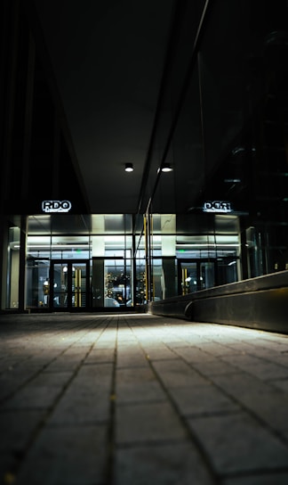 A sleek, dark-themed office lobby with a person effortlessly entering using hands-free access technology.