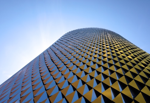 a very tall building with a sky background