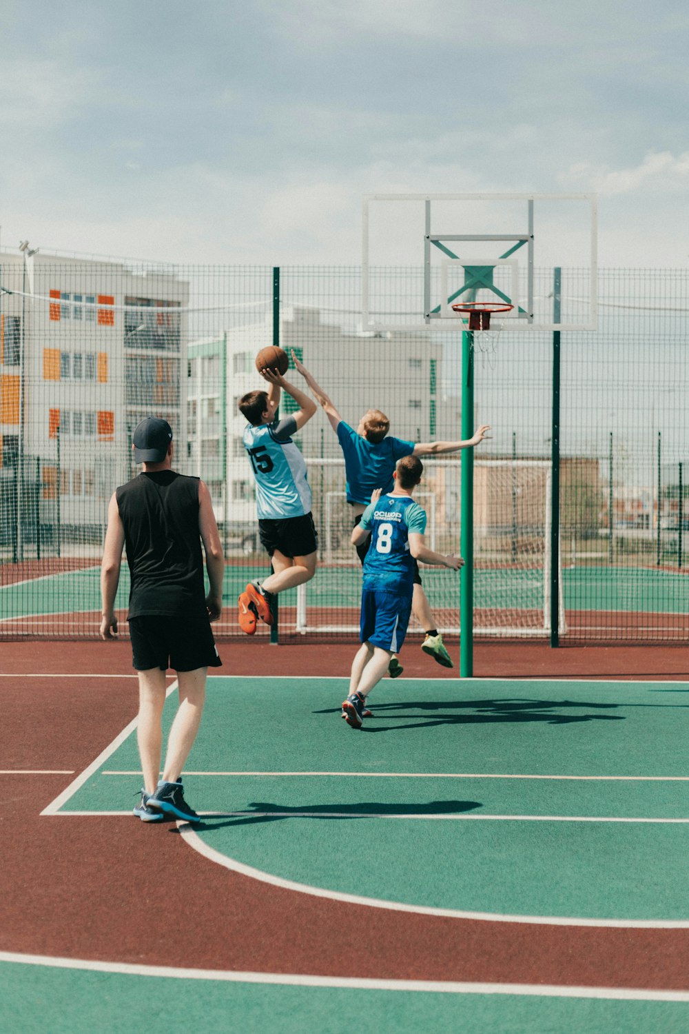 a group of young men playing a game of basketball