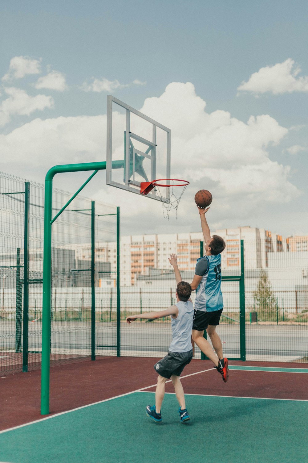 a couple of young men playing a game of basketball