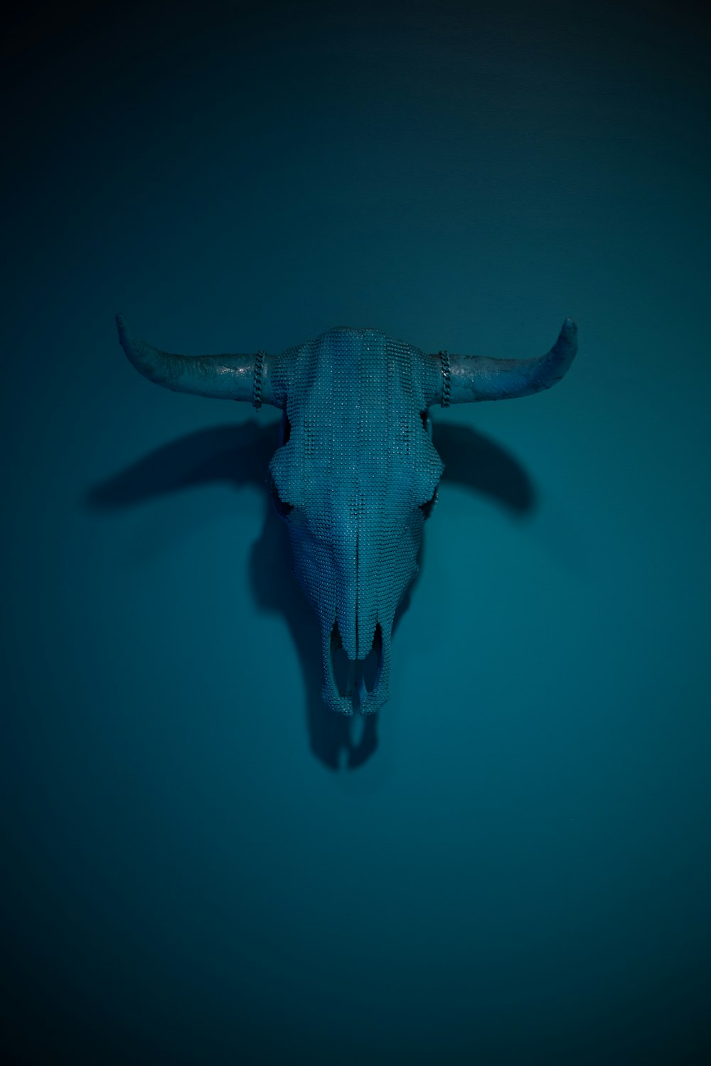 a bull's head is shown in the middle of a dark blue background