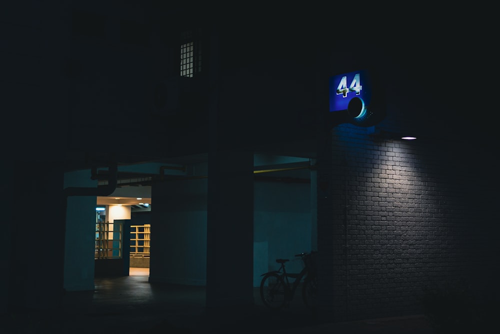 a bike is parked outside of a building at night