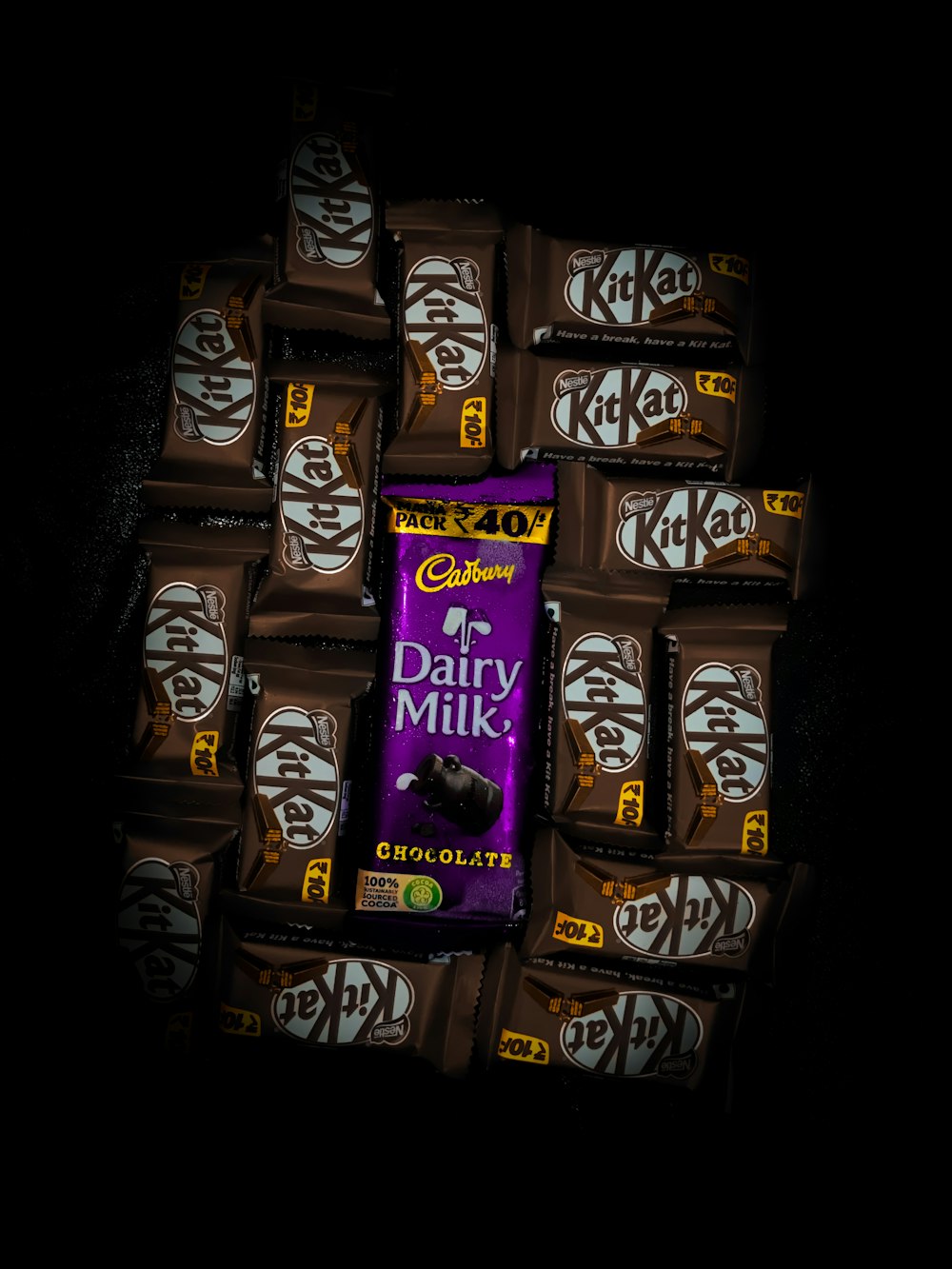 a pile of dairy milk chocolate bars stacked on top of each other
