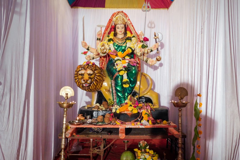 a statue of a woman sitting on top of a table