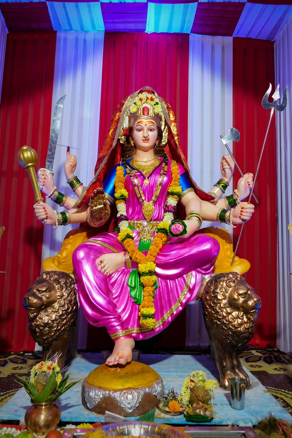 a statue of a hindu god sitting on a throne