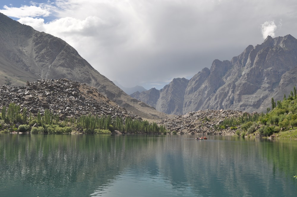 a body of water surrounded by mountains and trees