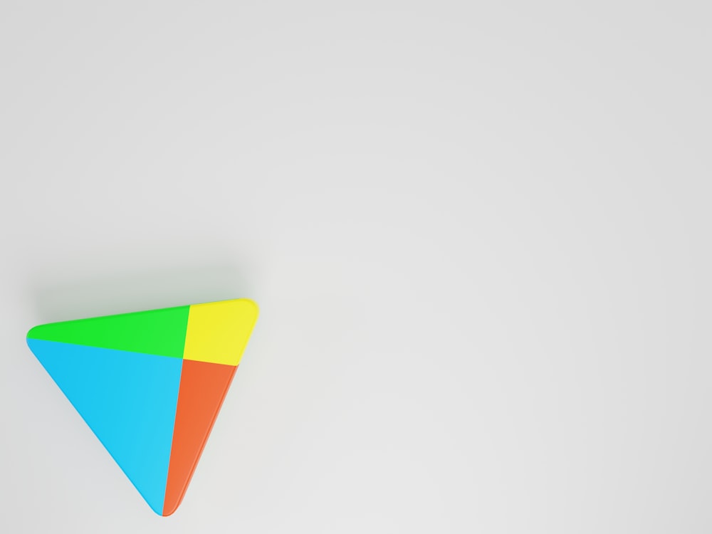 a colorful triangle shaped object on a white background