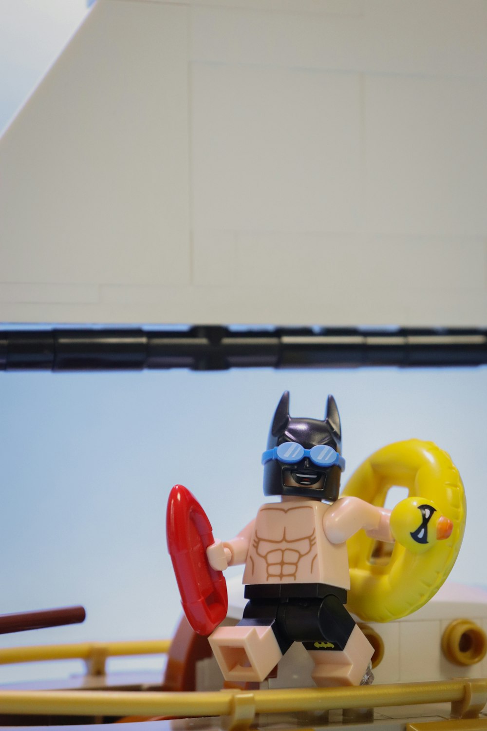 a lego figure is holding a frisbee