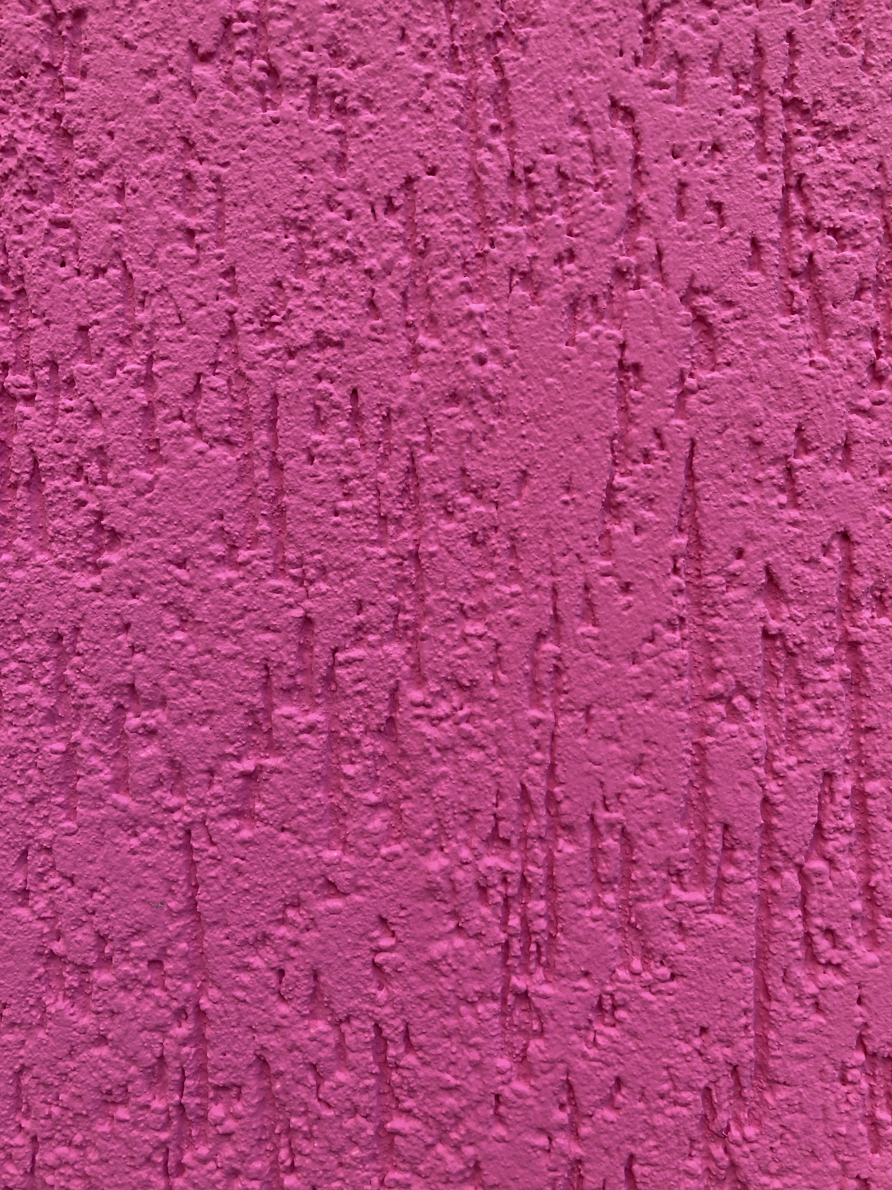 a pink wall with some writing on it