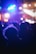 Crowd at a lively music concert with colorful stage lights.