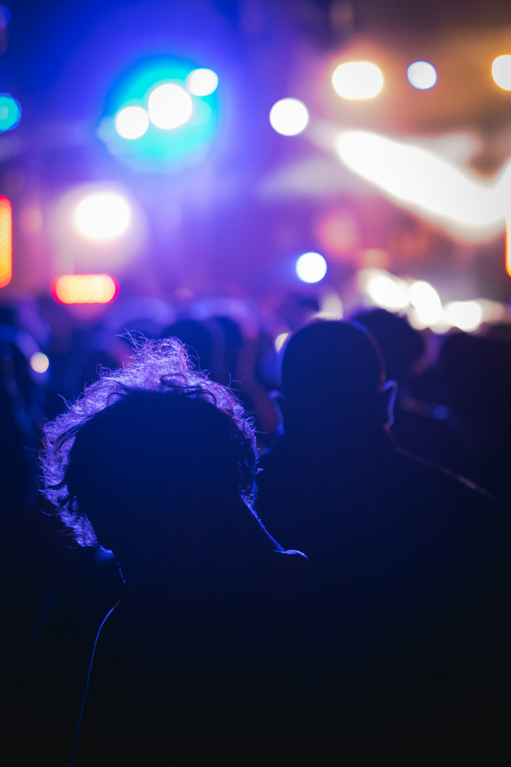 a crowd of people standing in front of a stage