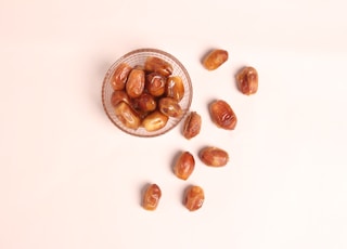 a glass bowl filled with nuts on top of a table