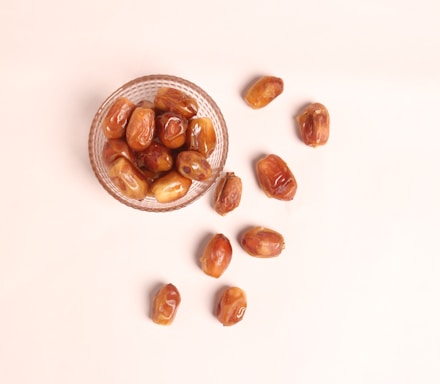 a glass bowl filled with nuts on top of a table