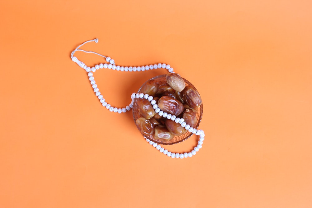 a beaded necklace on an orange background