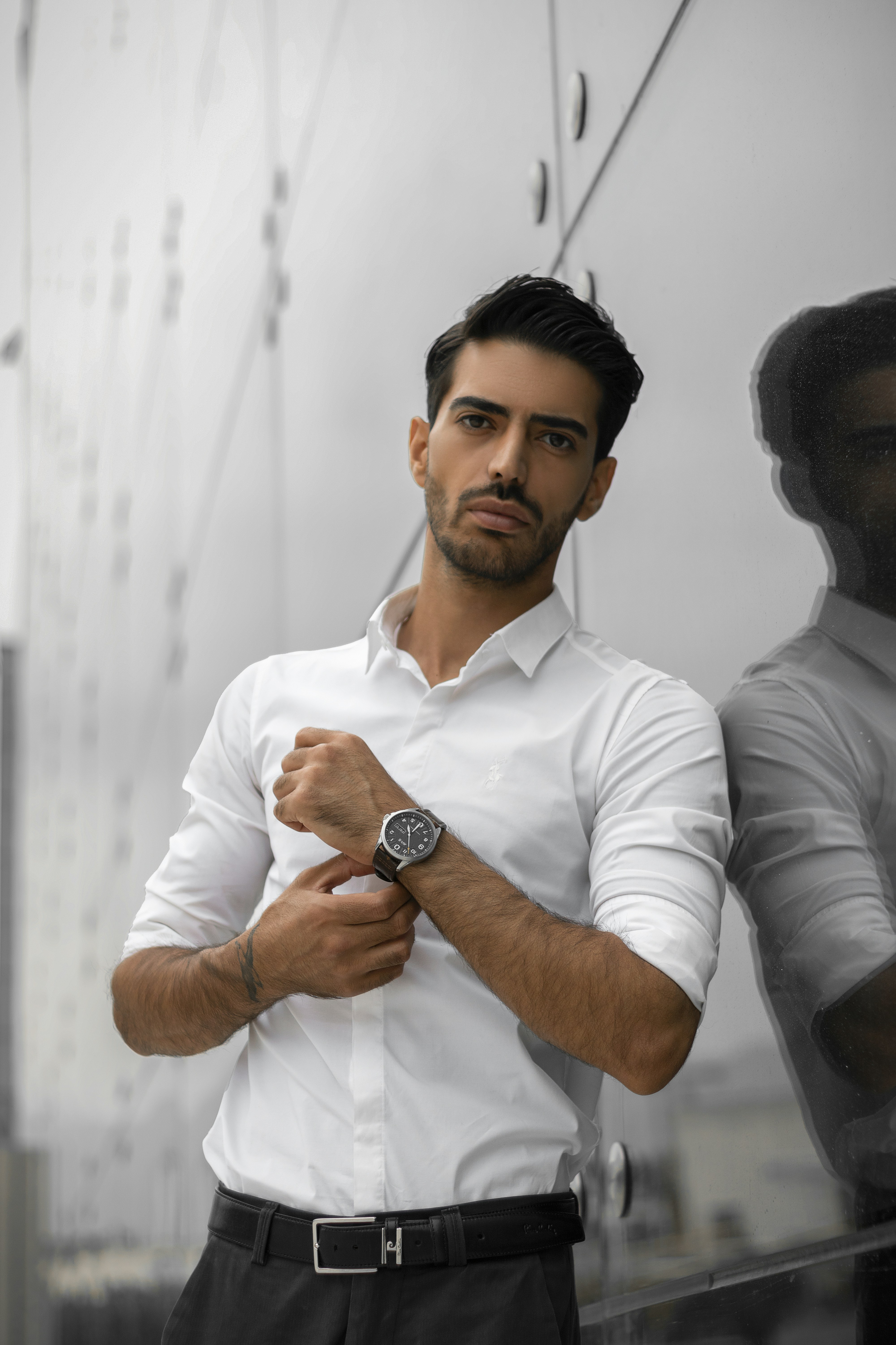 a man in a white shirt and black pants