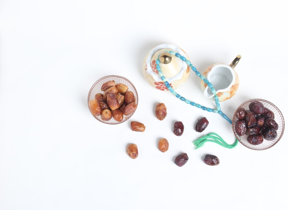 a white table topped with bowls filled with nuts