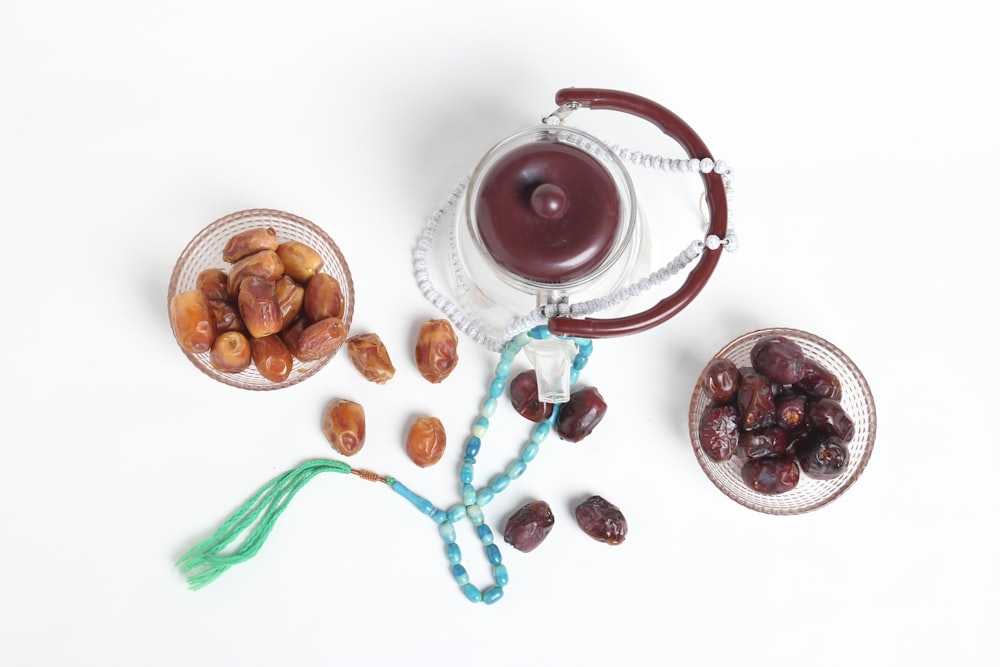 a bowl of nuts, a tea pot and a glass of water