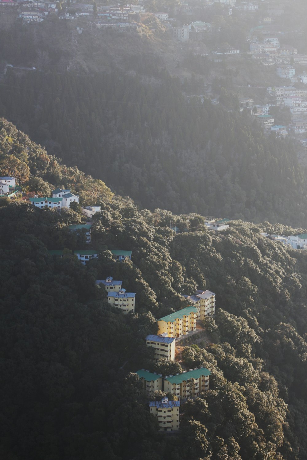an aerial view of a building on a hillside