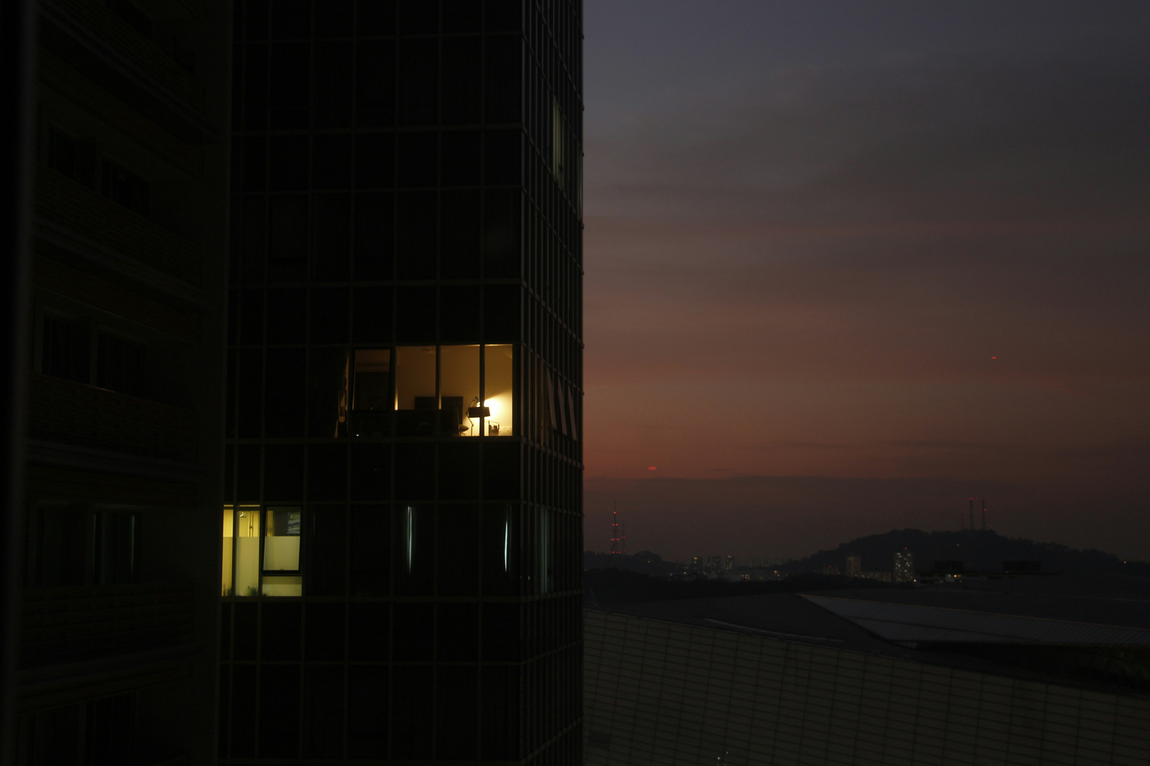 Full-floor penthouse residence at dusk with city lights - Chicago penthouse apartments
