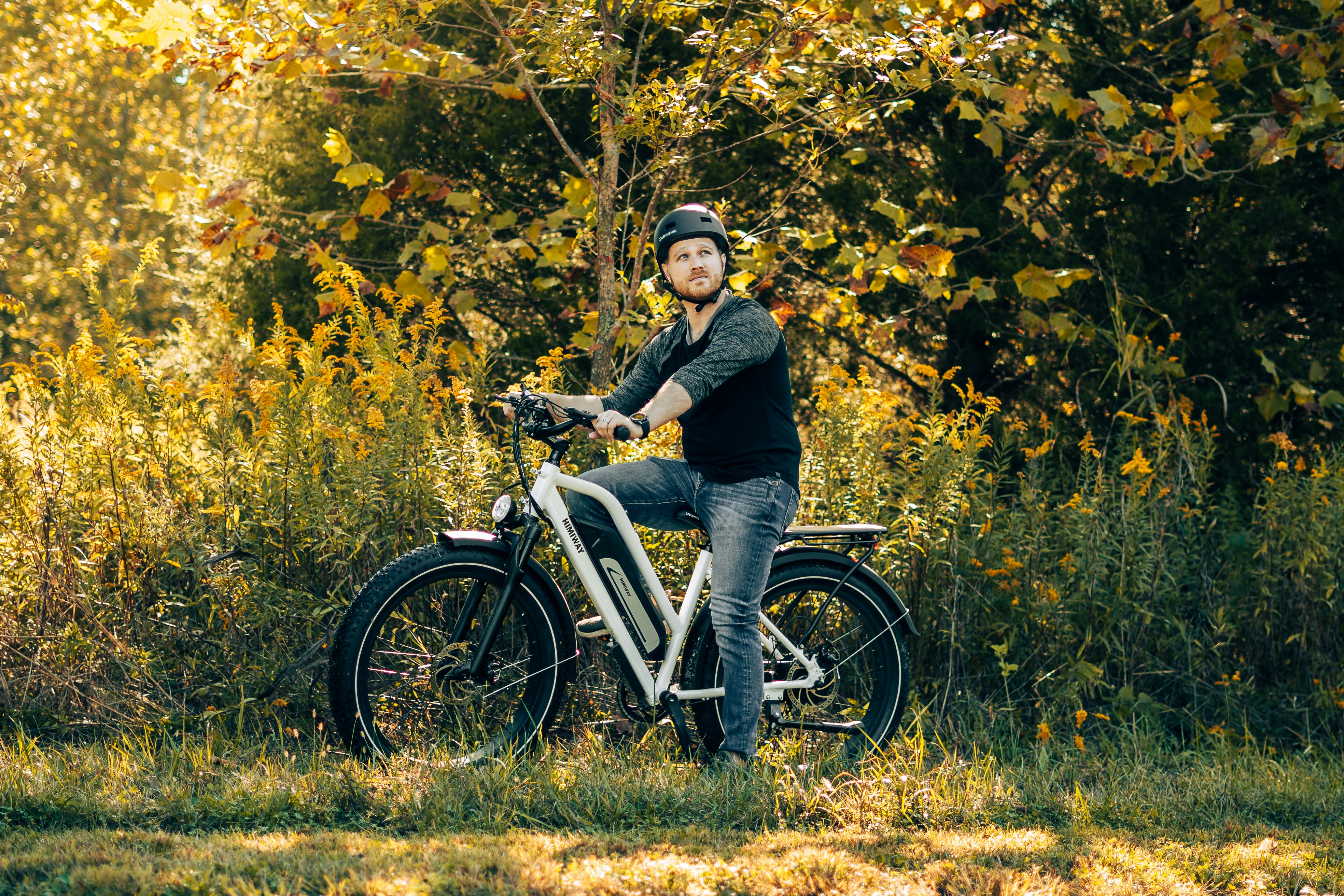 a man is sitting on a bicycle in the woods