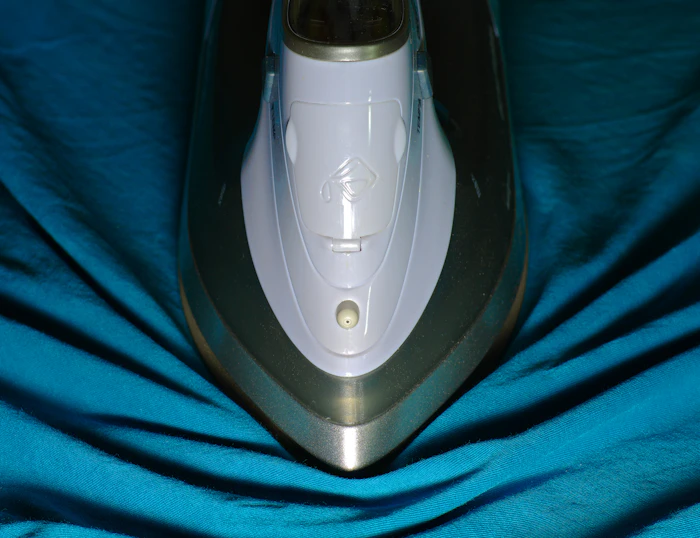Close-up of an iron pressing crisp cloth