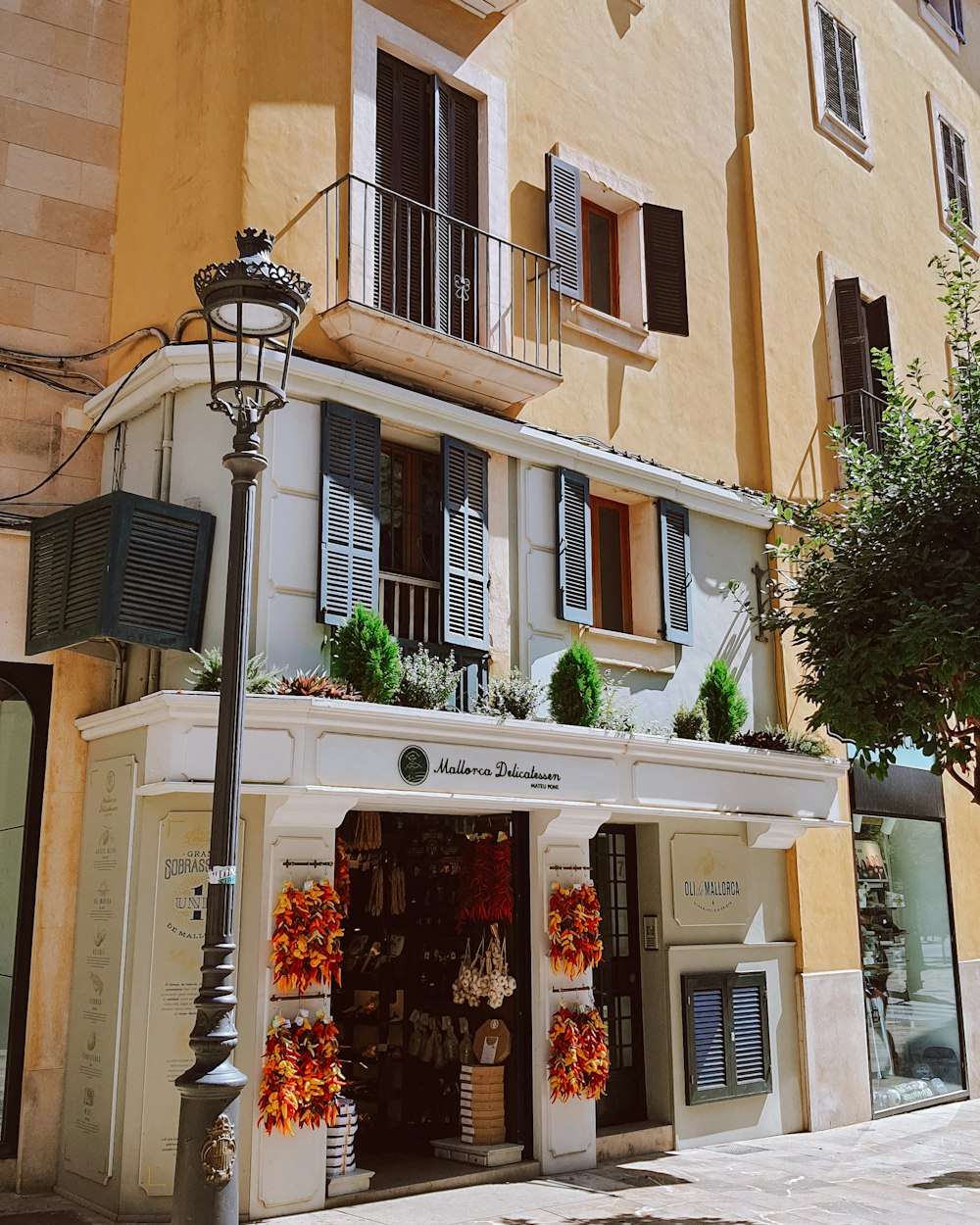 a building with a store front and a lamp post