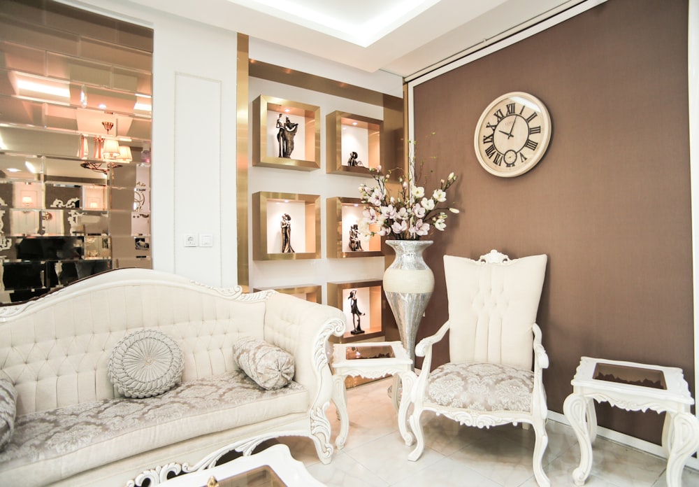 a living room filled with furniture and a clock on the wall