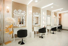 a hair salon with chairs and mirrors