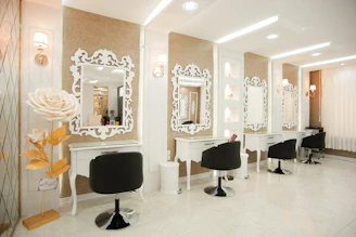 a hair salon with chairs and mirrors