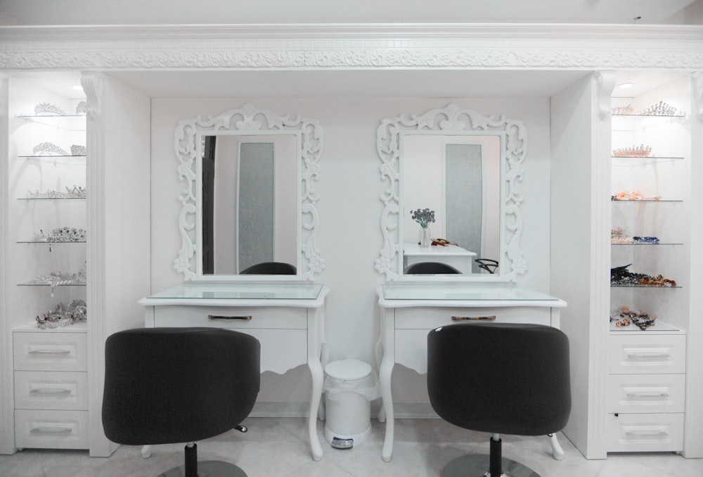 a white room with two chairs and a vanity