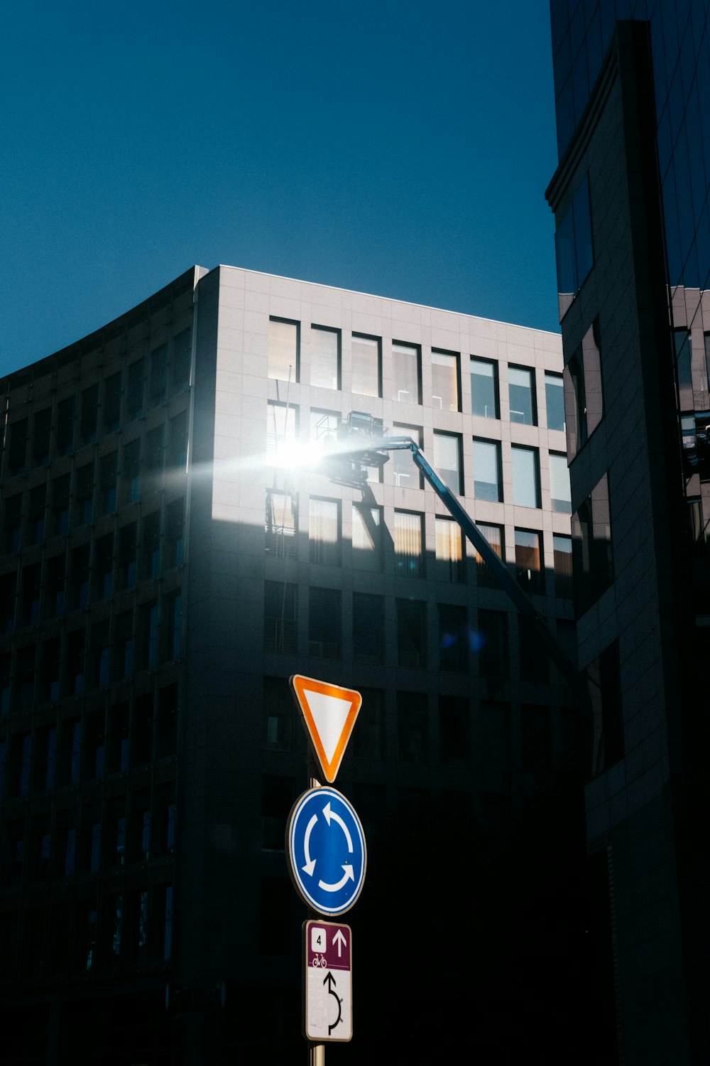 a street sign with a building in the background