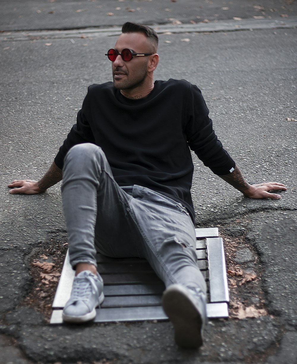 a man sitting on the ground with his legs crossed