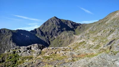 a view of a mountain range from the top of a hill