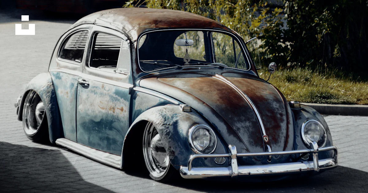 Old Vw Bug Rusted A rusted volkswagen beetle sitting on the side of a road photo – Free ...