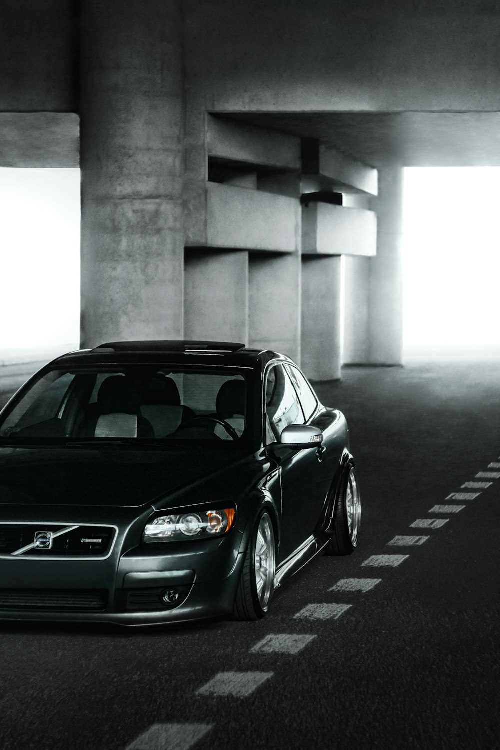 a black car parked in a parking garage