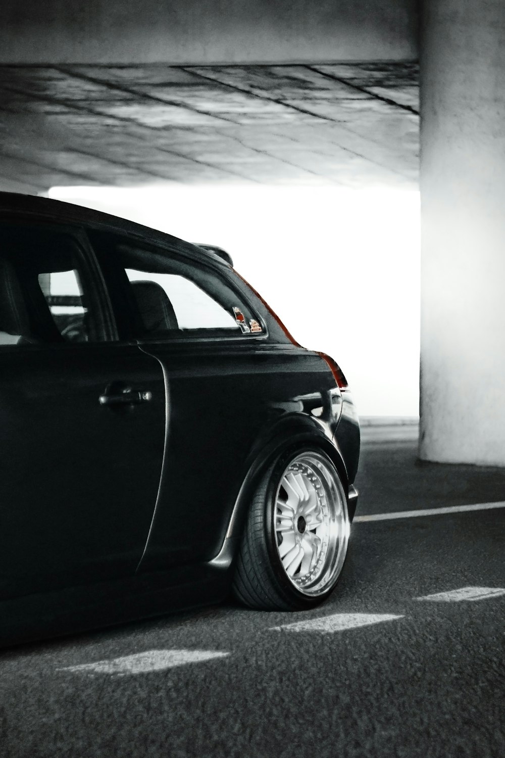 a black car parked in a parking garage