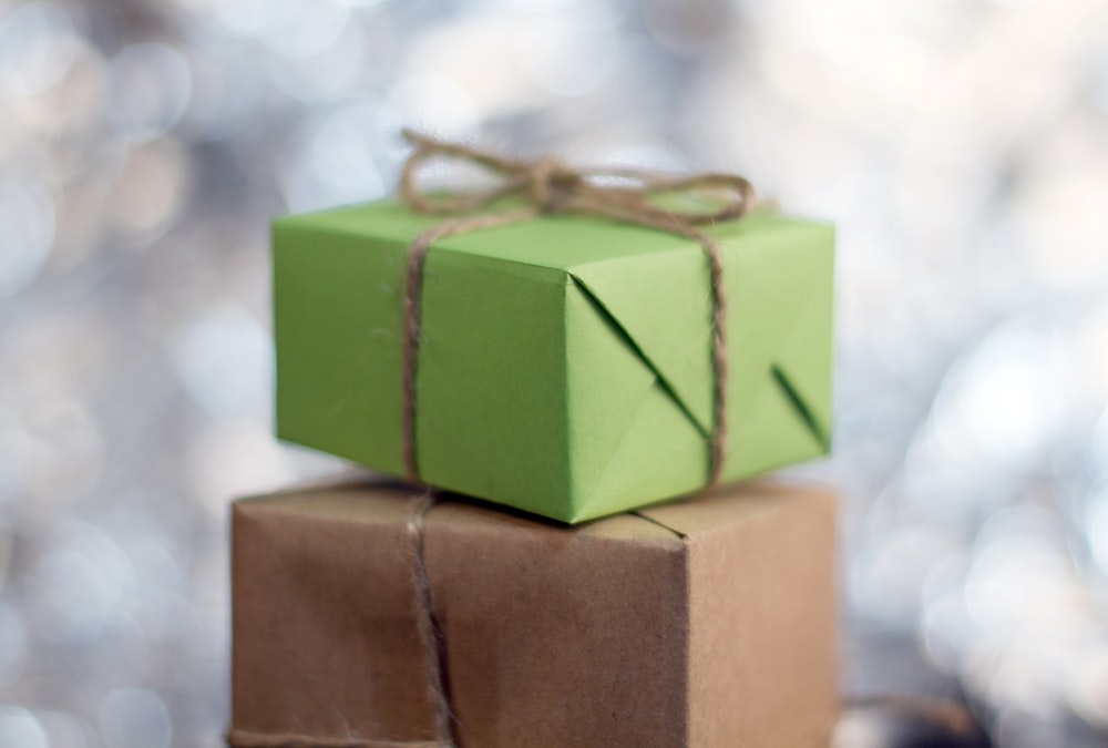 two wrapped presents sitting on top of each other