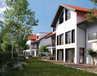 a row of white houses with a red roof