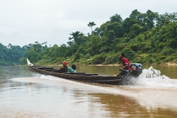 a group of people riding on the back of a boat