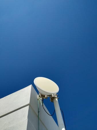 A satellite dish mounted on the side of a building
