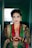 a woman in a green and red outfit