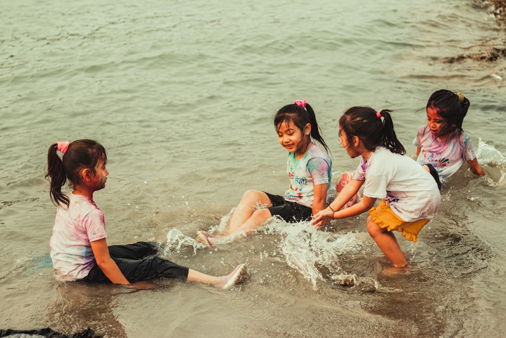 a group of children playing in the water