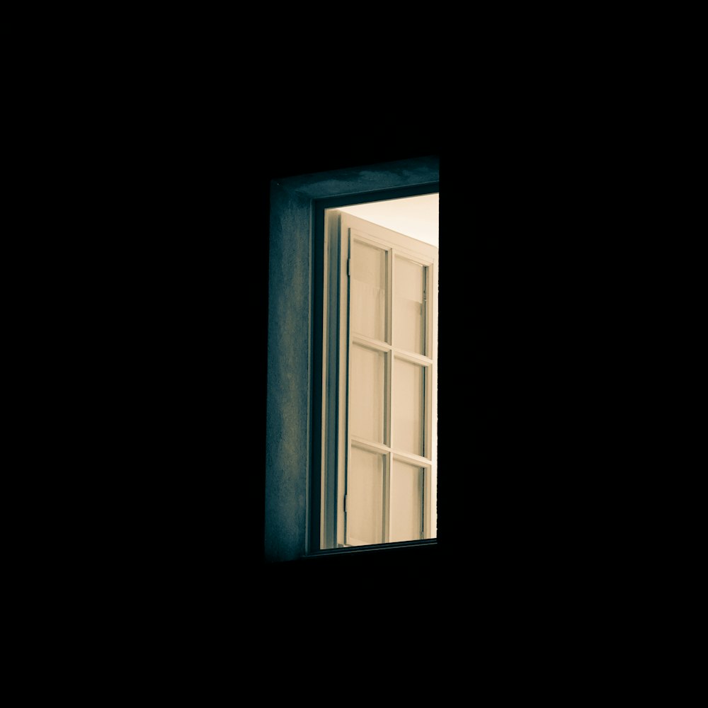 an open window in a dark room at night